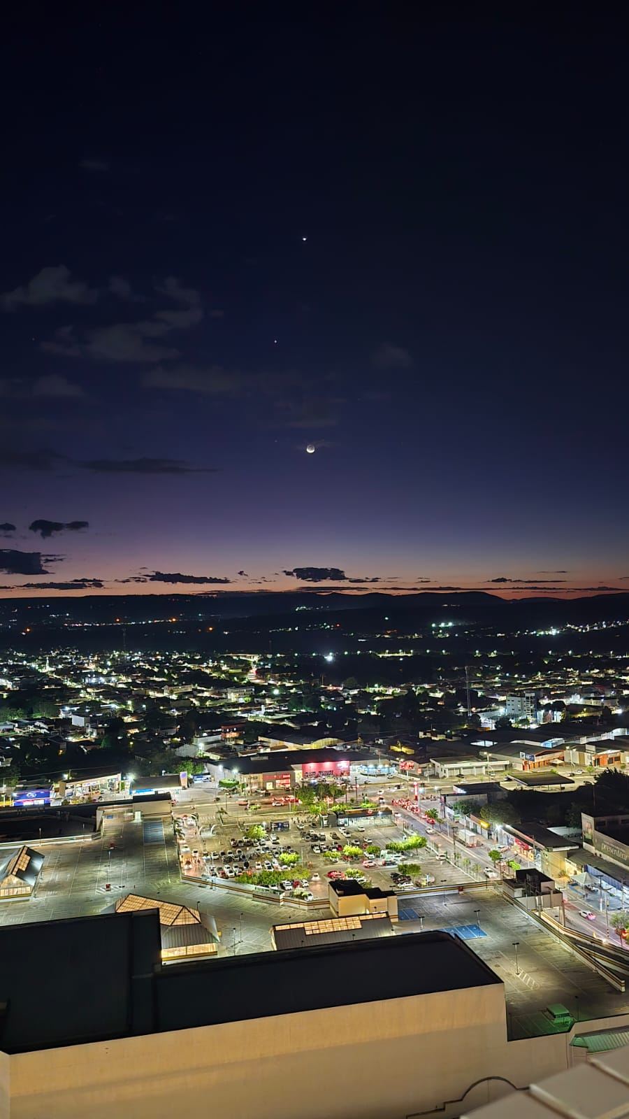 A cidade iluminada e a lua vistas do Gran Vista